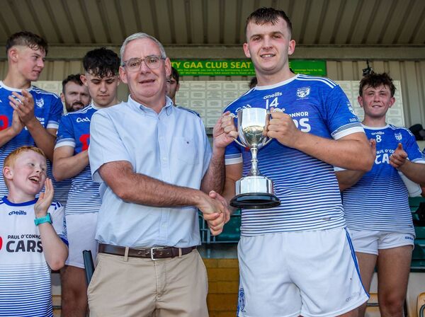 County board chairman Neil Moore presents the cup to Fourmilewater captain Michael O'Sullivan after they defeated Ballygunner in their J.J Kavanagh & Sons Junior B hurling Co. Final played in Lemybrien. County board chairman Neil Moore presents the cup to Fourmilewater captain Michael O'Sullivan after they defeated Ballygunner in their J.J Kavanagh & Sons Junior B hurling Co. Final played in Lemybrien.