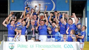 <p>Mount Sion captain Evan McGrath lifts the Junior A County trophy after the presentation from board chairman Neil Moore at Cappoquin Logistics Fraher Field. Photo: Noel Browne</p>