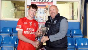 <p>The late Brendan Breen presents the Under 16 Cup to Stradbally's U16 Division 1A trophy to captain Gearóid Power. Photo: Eddie Dee</p>