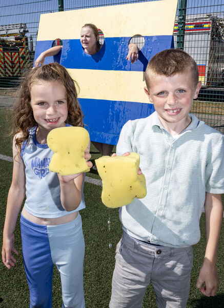  Mona and Ollie get ready to wet Mary Lyng, who was up for the wet sponge challenge, at the Sacred Heart Family Fun Day. Photo: Joe Evans