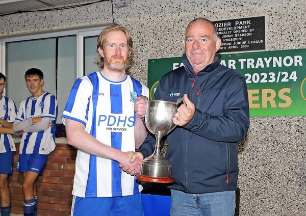 Piltown's captain Martin Harney is presented with the Philip O'Keeffe Div.3 Cup by Noel O'Keeffe. Piltown's captain Martin Harney is presented with the Philip O'Keeffe Div.3 Cup by Noel O'Keeffe.