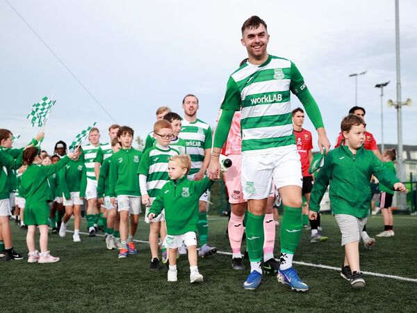 Villa captain Luke Walsh leads his team onto the pitch with mascot Reuben Coad during the FAI National League game with UCC. Villa captain Luke Walsh leads his team onto the pitch with mascot Reuben Coad during the FAI National League game with UCC.