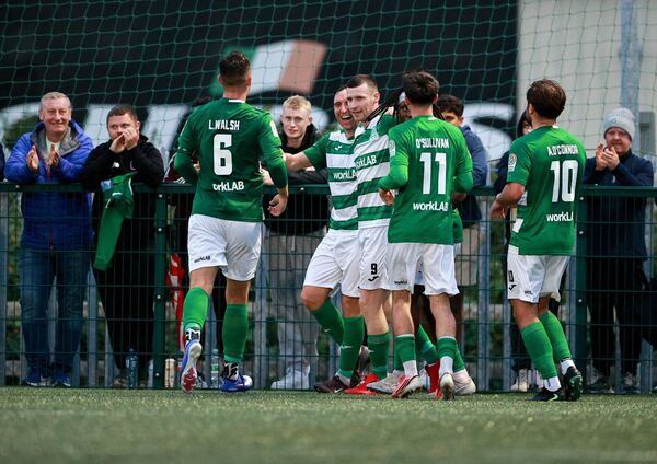 Dean Walsh of Villa celebrates with teammates after scoring his side's third goal during the FAI National League match between Villa and UCC at workLAB Connors Park. Dean Walsh of Villa celebrates with teammates after scoring his side's third goal during the FAI National League match between Villa and UCC at workLAB Connors Park.
