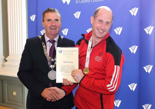 The Mayor of Waterford City &amp; County, Cllr. Liam Brazil presents Carriglea Special Olympics Club member Michael Landers with his scroll. 	Photo: Noel Browne